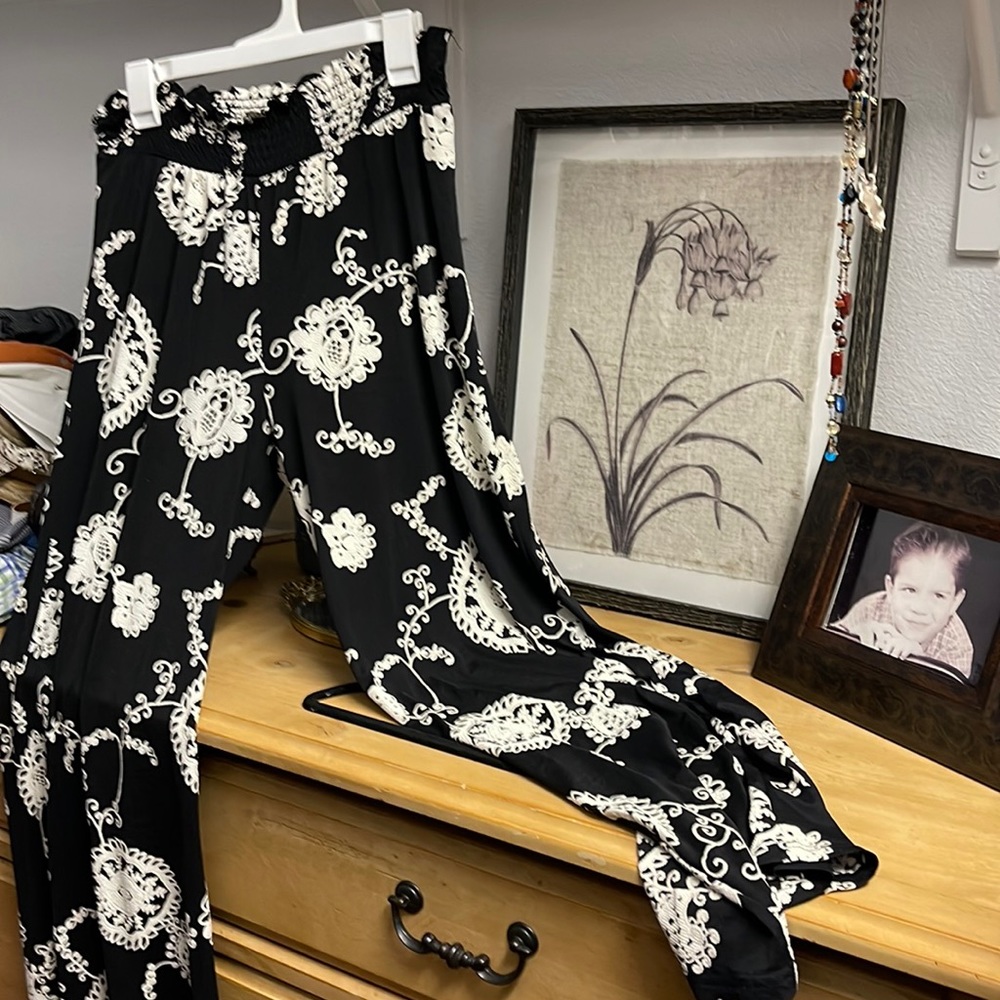 Black with “flocked cream design. Elastic waist and your loose legged.